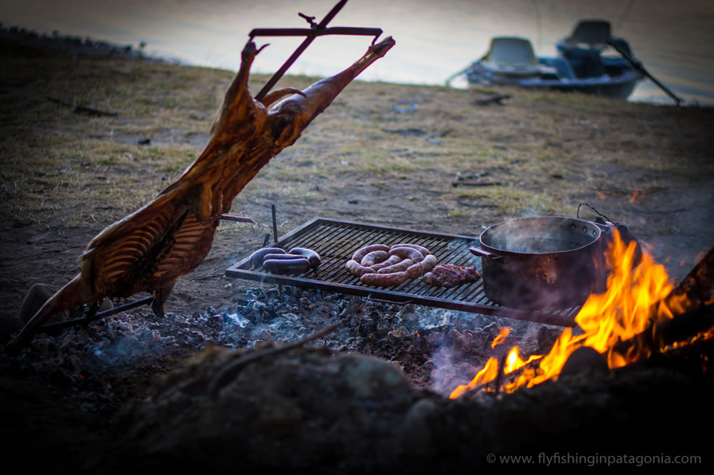 Lamb asado cooking by the river