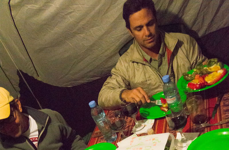 Guest enjoying dinner in the dining tent
