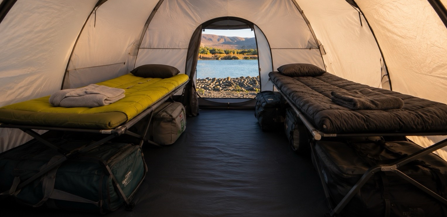Comfortable tent interior with river view