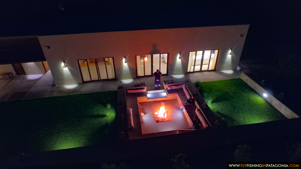 aerial night view of the fire pit and quincho at Limay River Lodge