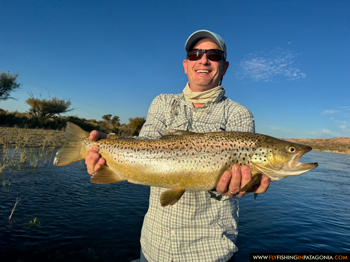 Fly angler holding a large Middle Limay River brown trout
