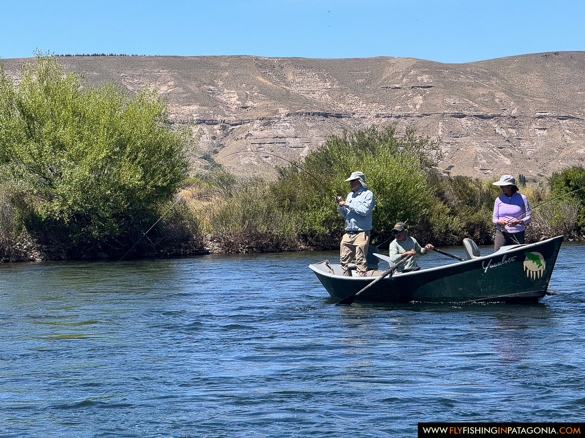 three anglers fishing together from the drift boat on the Chimehuin River