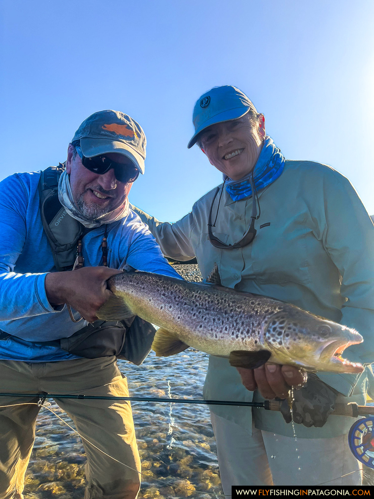 a couple with a beautiful brown trout from the Chimehuin River