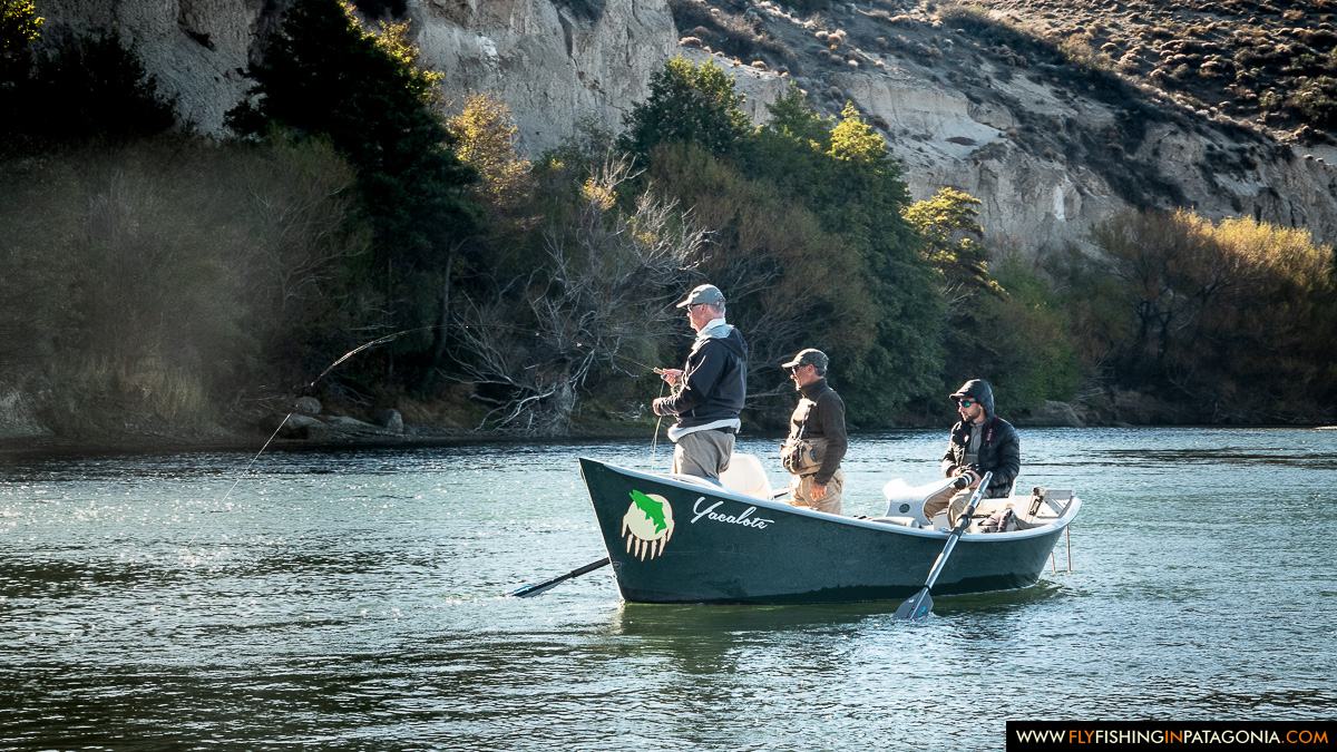 Guide rowing two anglers through a sunlit Collon Cura River run