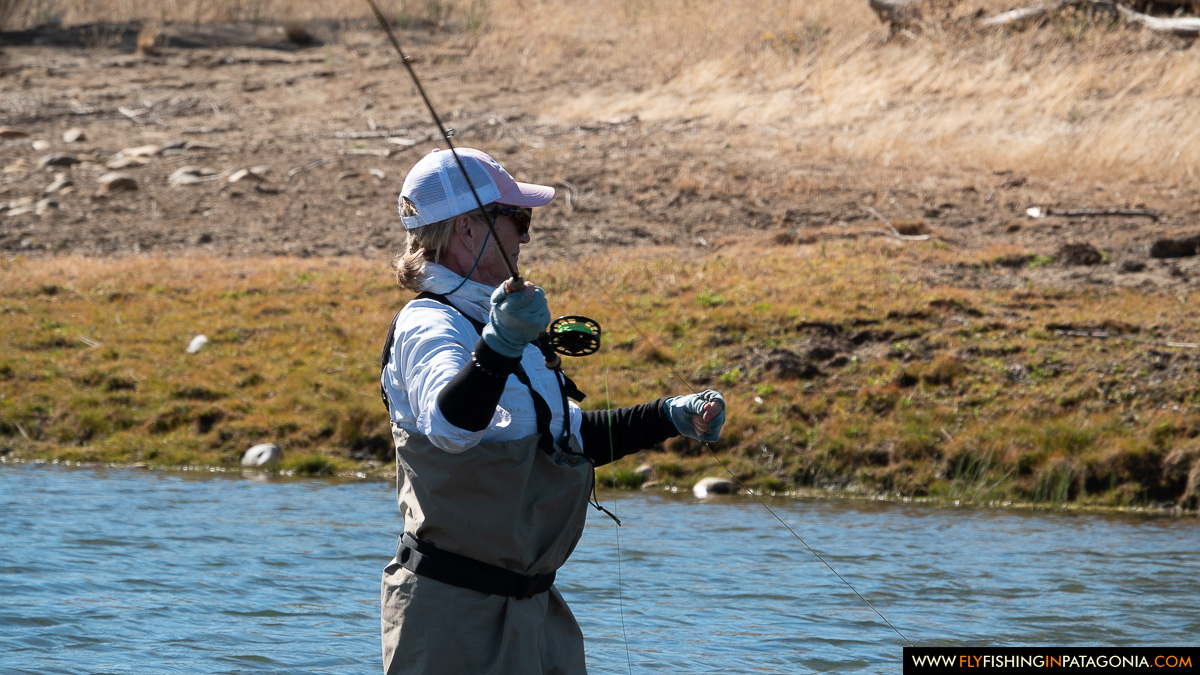 Fly angler casting from a gravel bank on the Collon Cura River