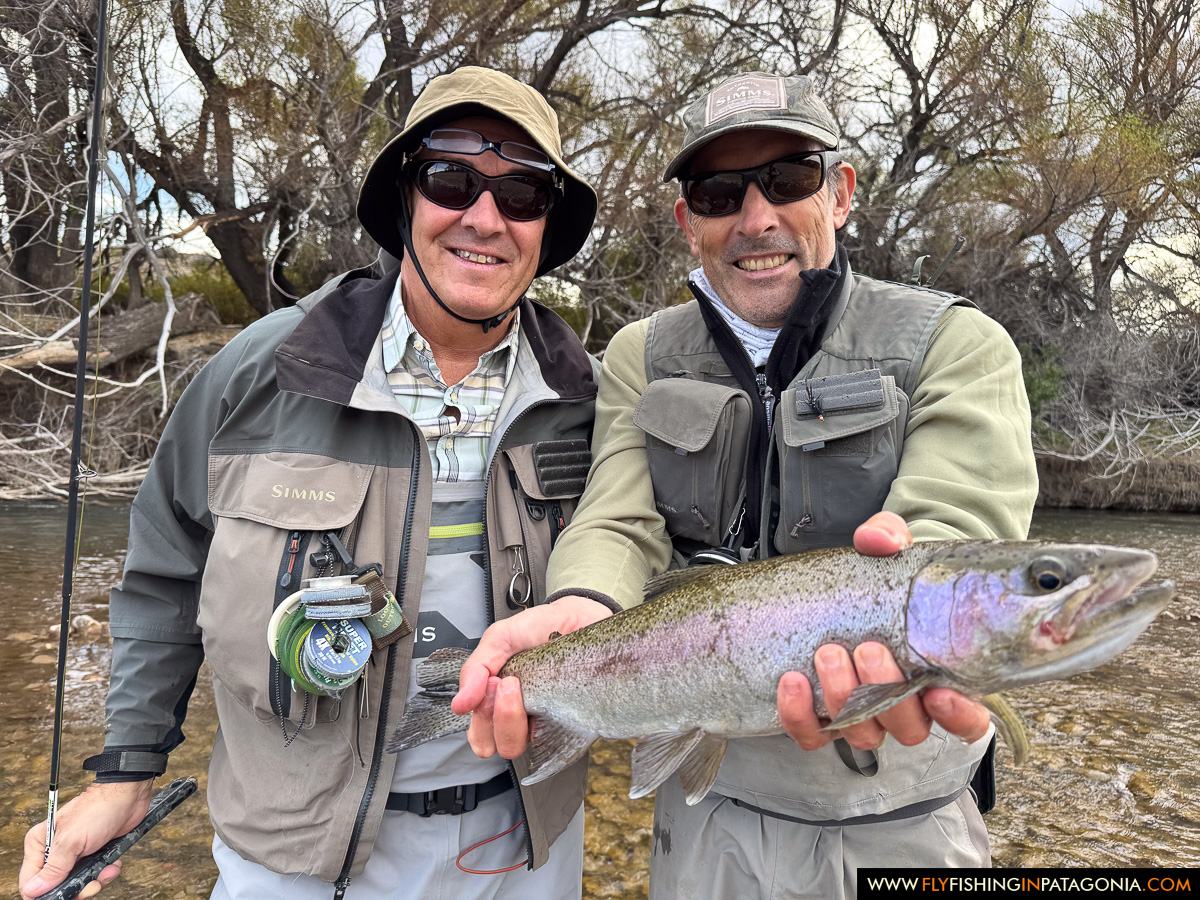 Two anglers holding a rainbow trout from the Collon Cura River