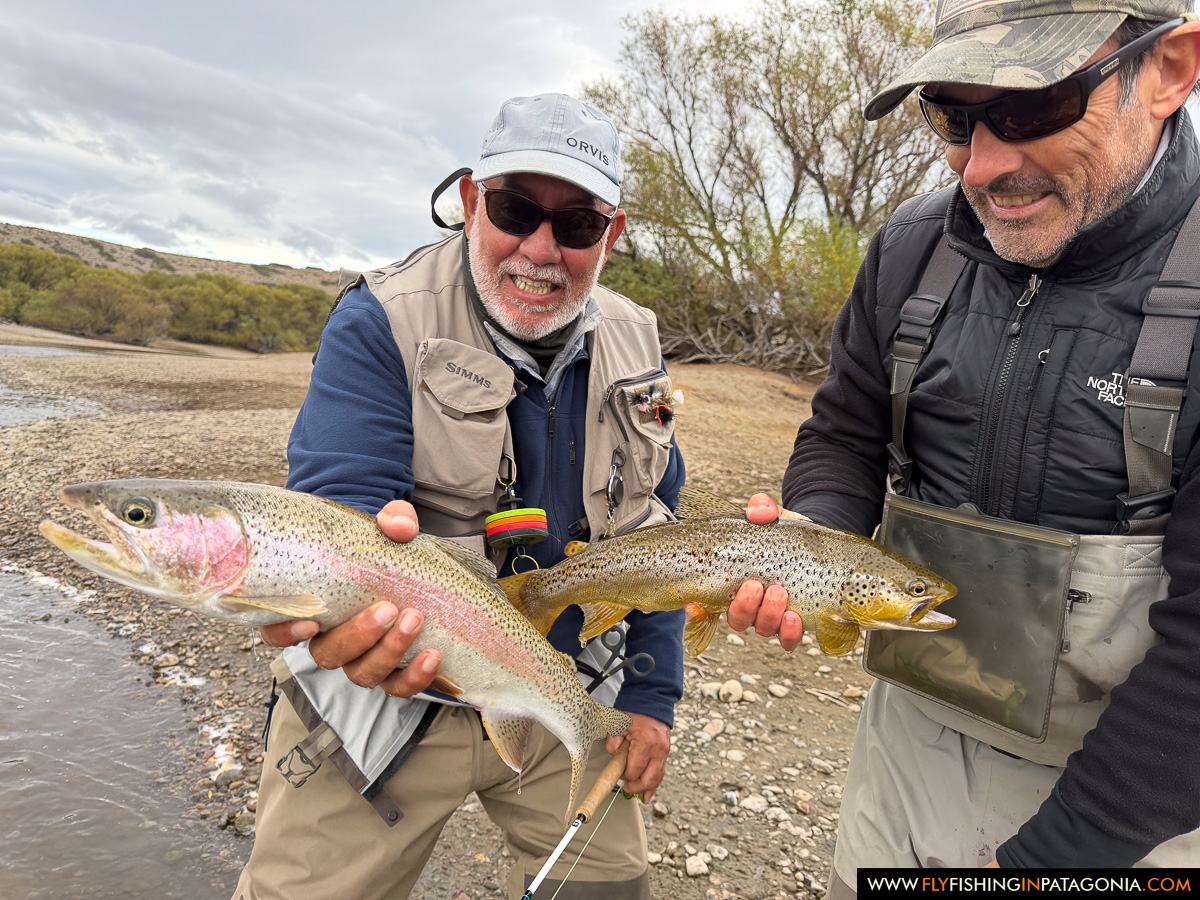 Two anglers holding a brown trout beside the Collon Cura River