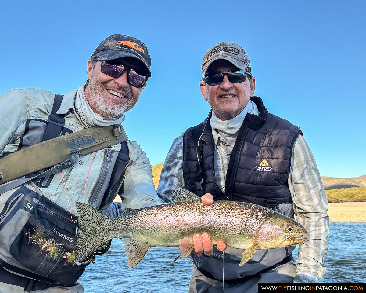 Two anglers with a wild trout from the Collon Cura River