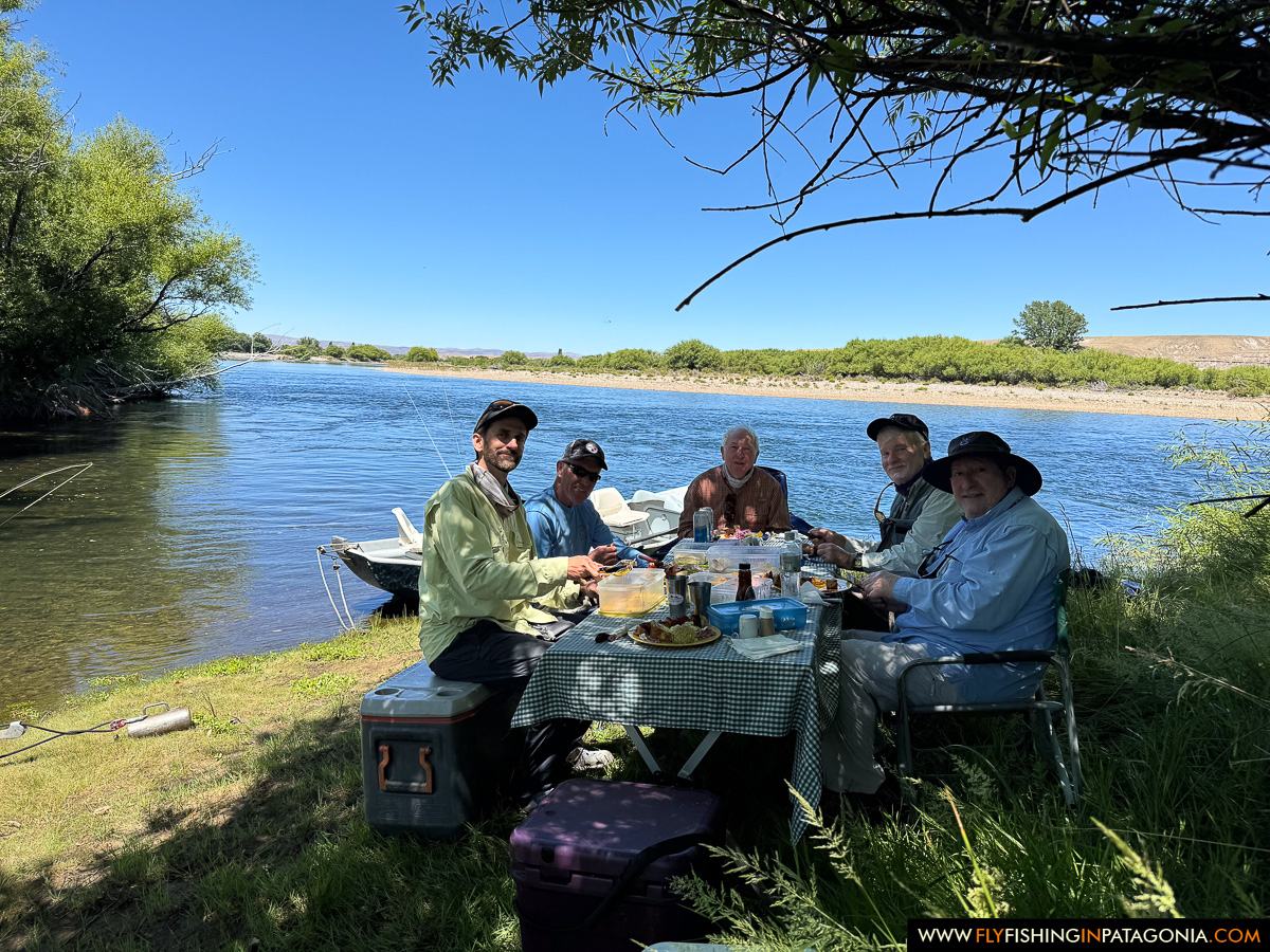 Guests enjoying a riverside lunch during a Collon Cura River fishing day