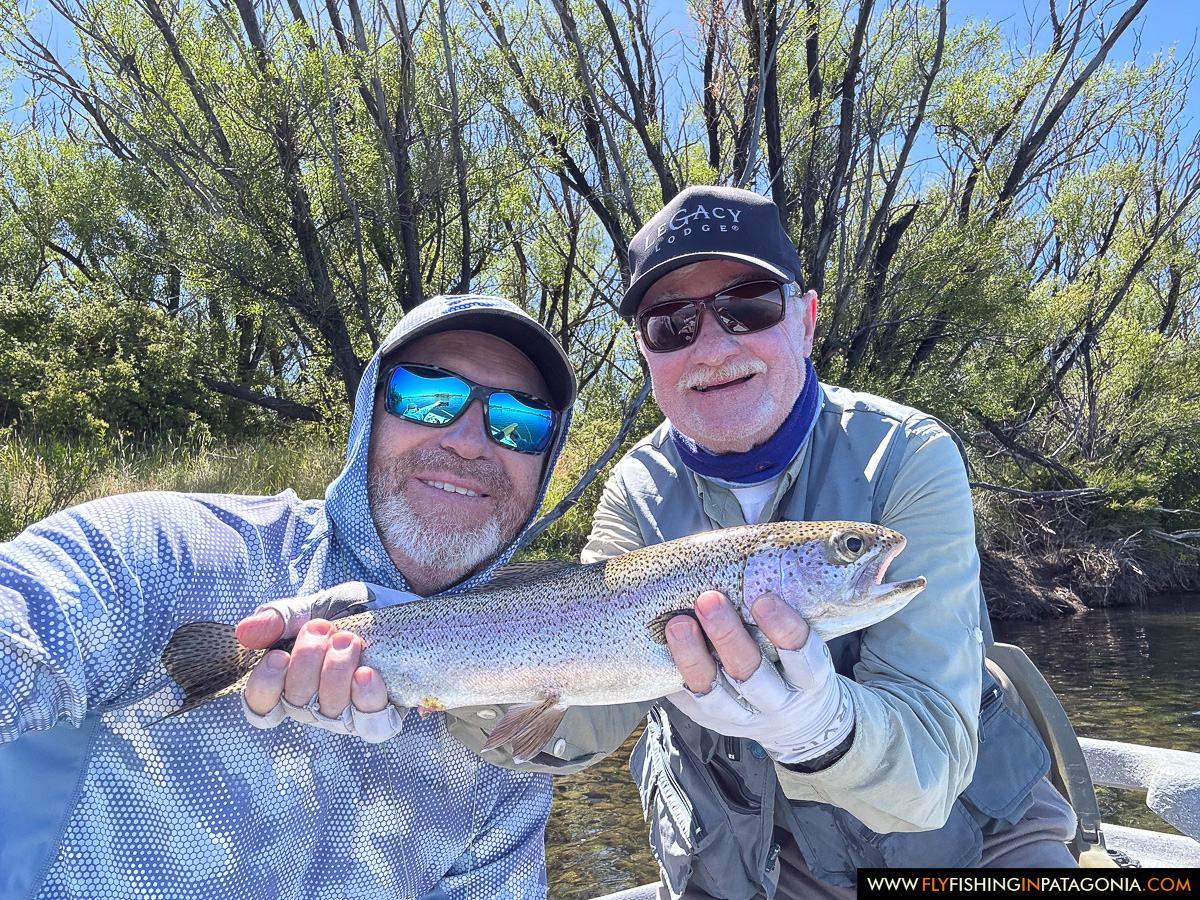 Two anglers holding a rainbow trout beside the Collon Cura River