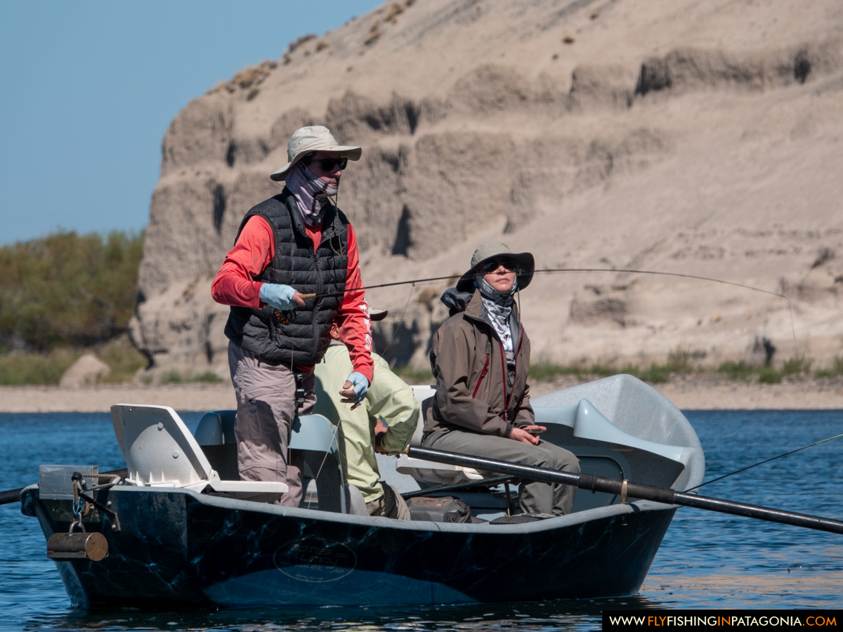Anglers fly fishing from a drift boat on the Collon Cura River