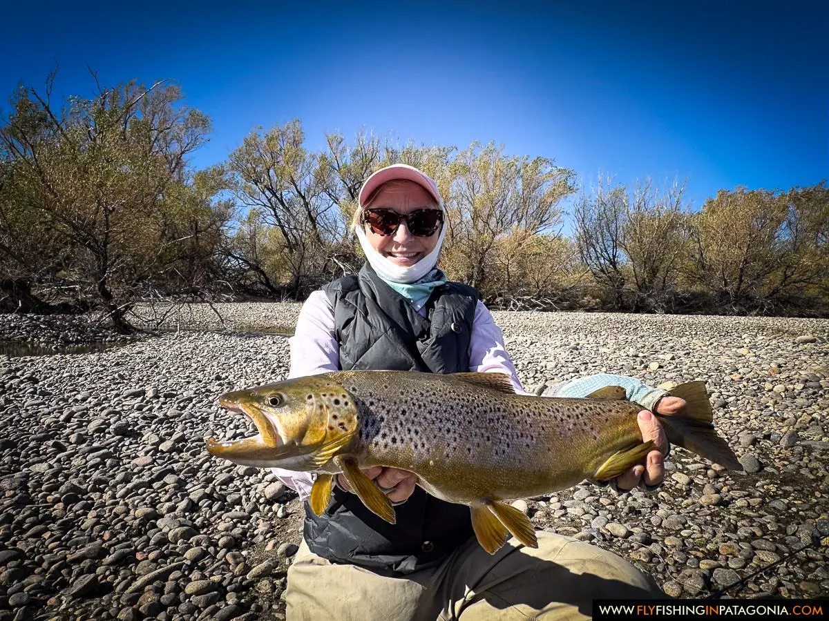 Hellen holding a large brown trout beside the Collon Cura River