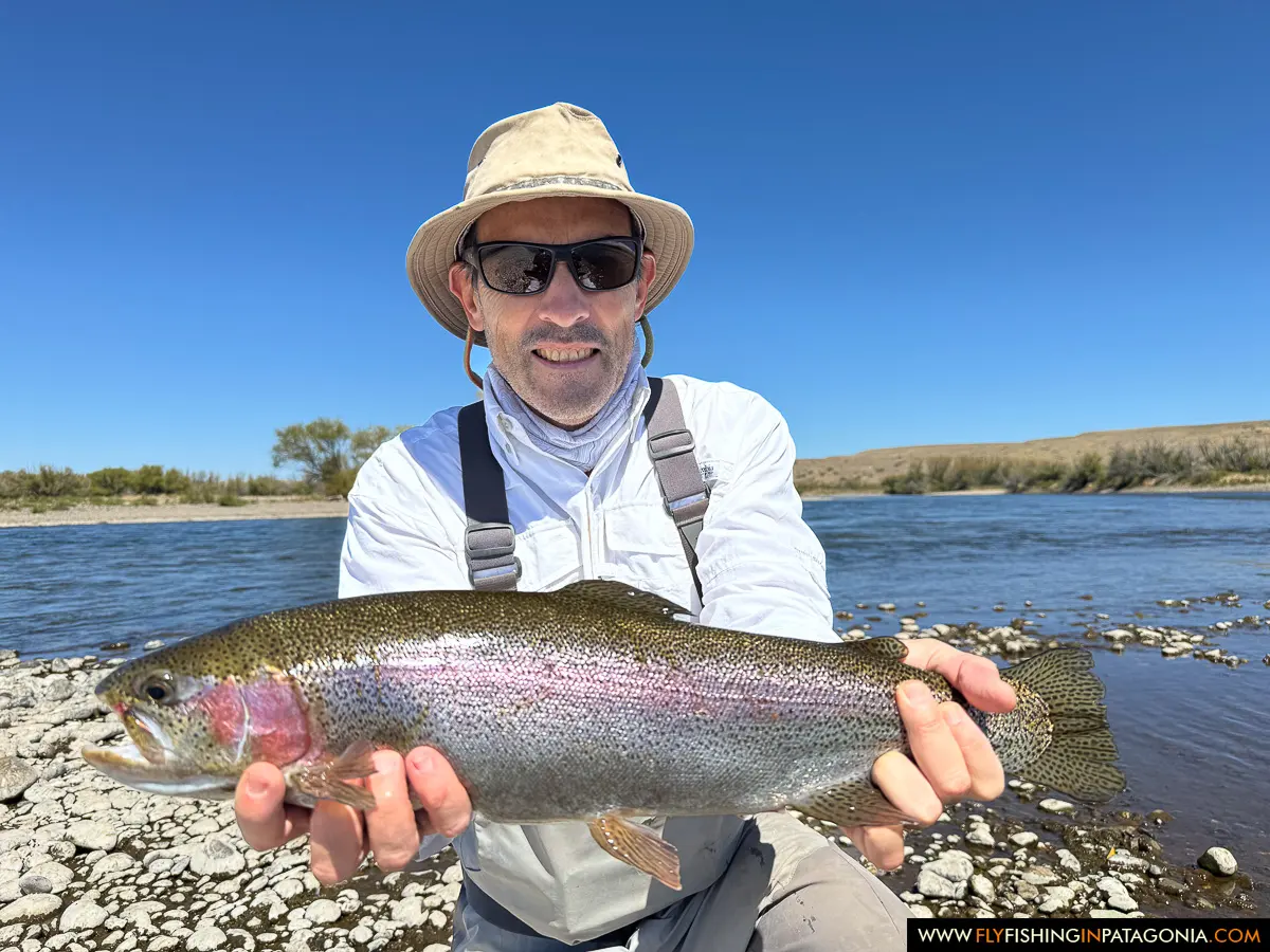 Angler holding a rainbow trout on the Collon Cura River
