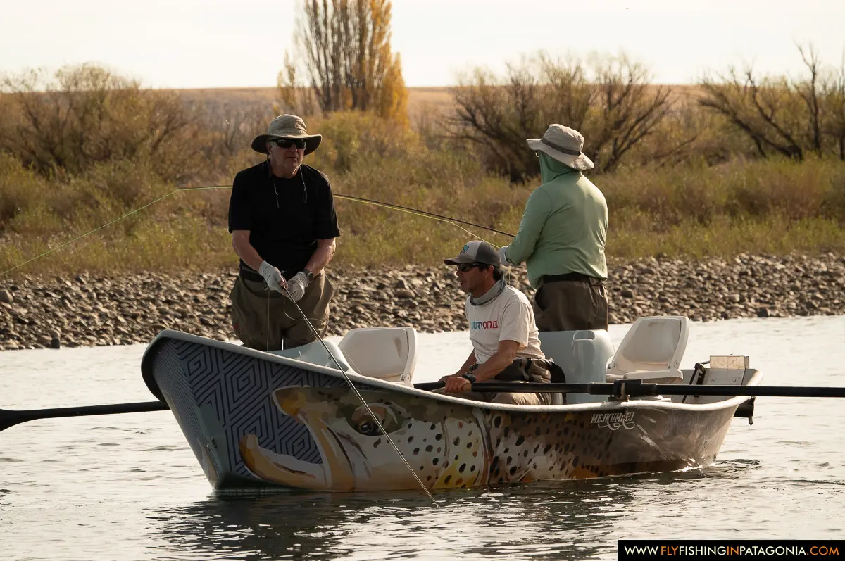 Anglers fishing from a painted drift boat on the Collon Cura River
