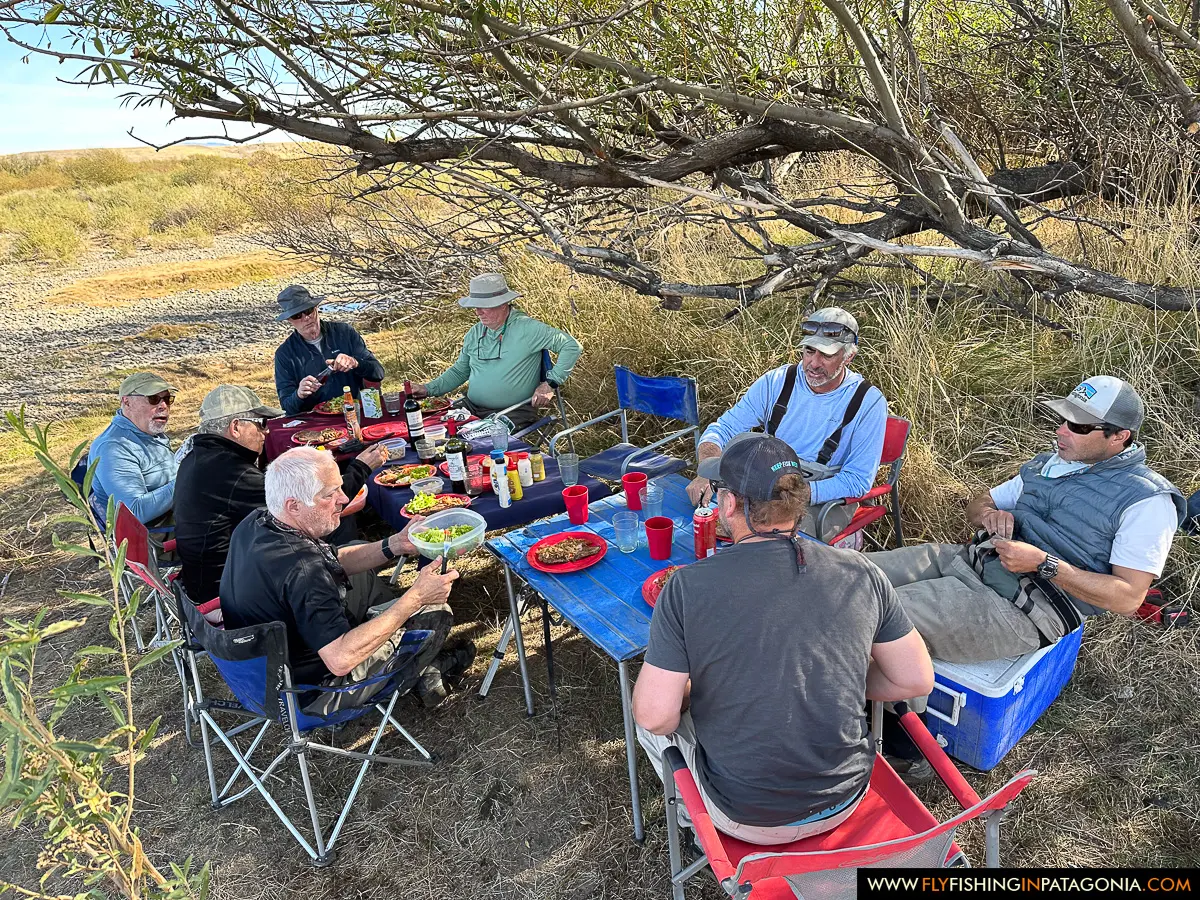 Fishing group enjoying a riverside lunch beside the Collon Cura River