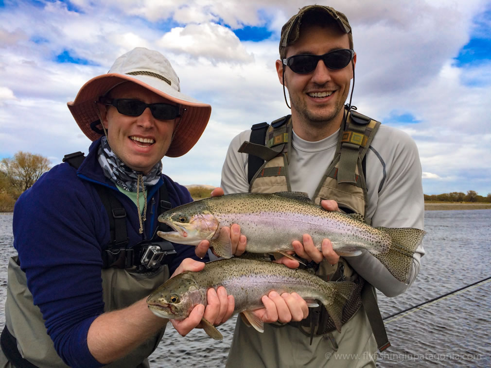 Two anglers celebrating a double catch on the Collon Cura River