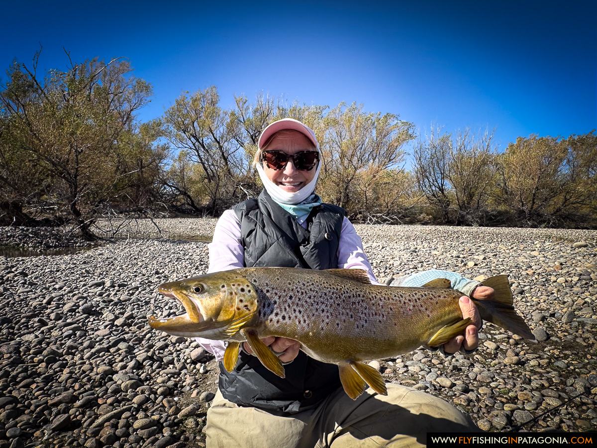 Hellen holding a large brown trout beside the Collon Cura River