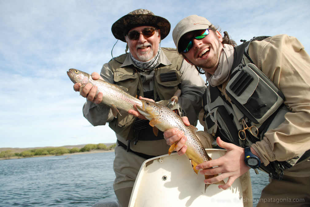Marce and Tomy with a trout aboard a drift boat on the Collon Cura River