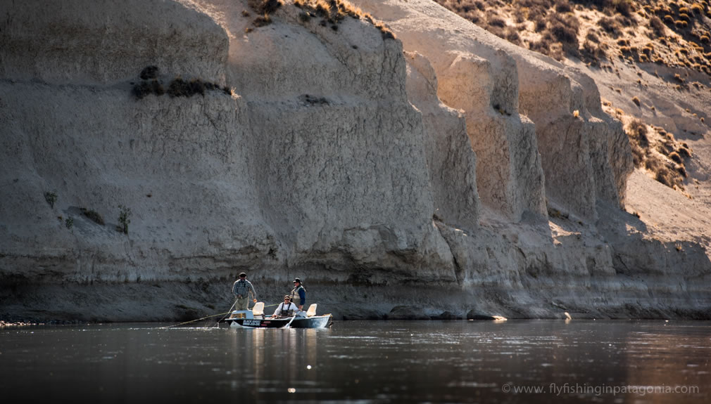 Drift boat floating beneath the cliffs of the Collon Cura River