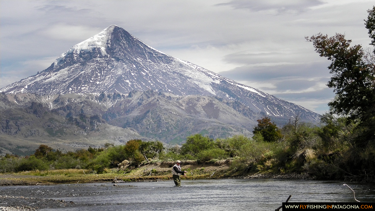 Fly angler on the Malleo River beneath Lanin Volcano