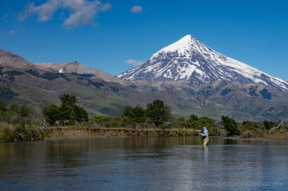 Art casting a fly on the Malleo River beneath Lanin Volcano