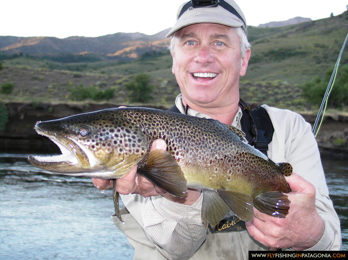Greg LeMond holding a large Malleo River brown trout caught on a dry fly