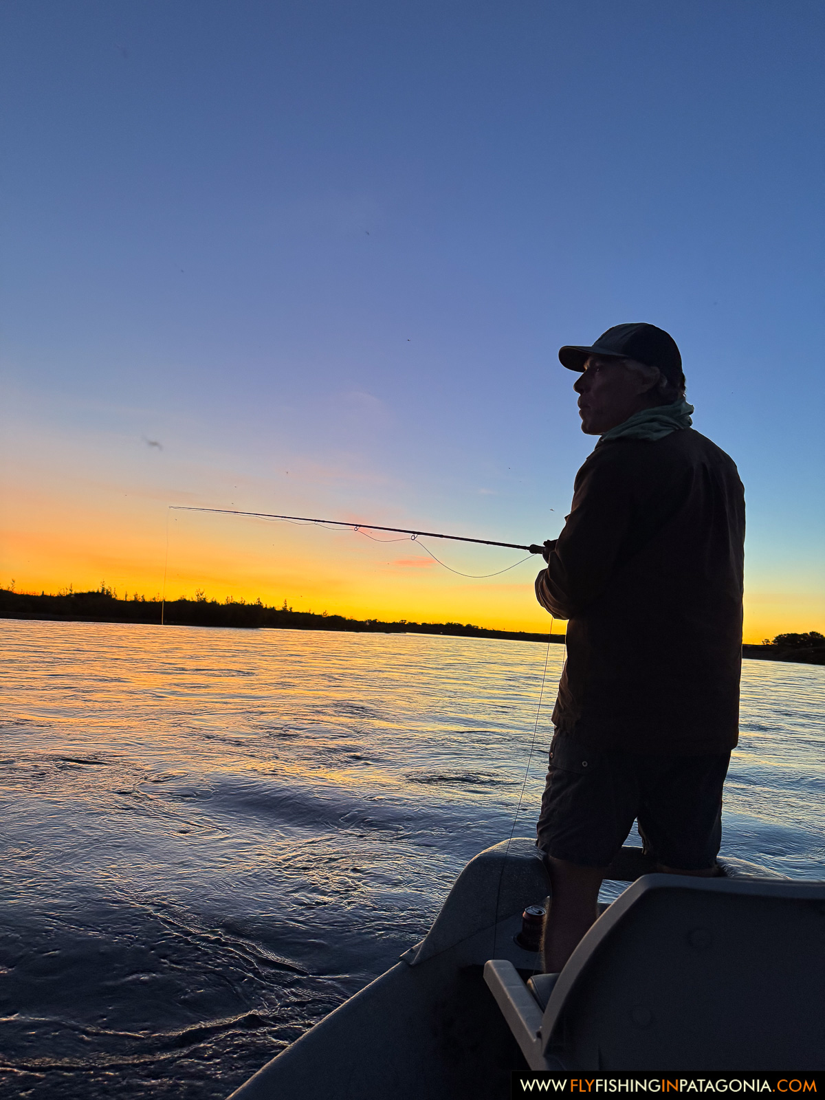 casting into the sunset from the bow of the boat on the middle limay river