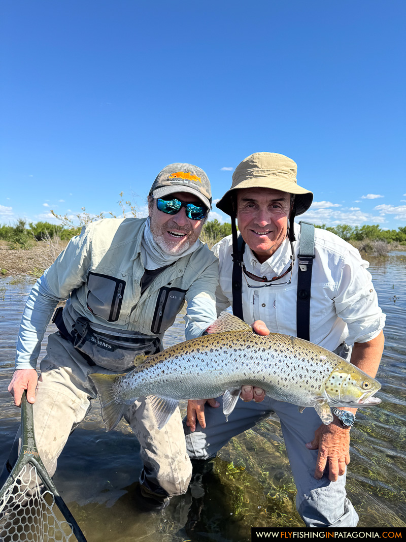 two anglers smiling with a large brown trout wade fishing the middle limay river