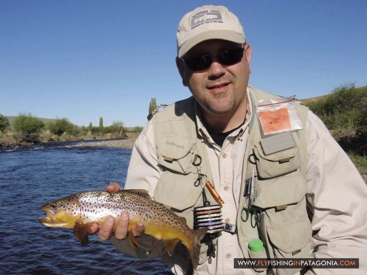 Angler holding a golden trout at sunset on the Quemquemtreu stream